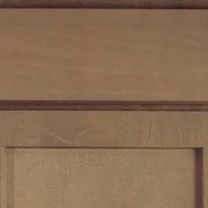 Close-up of a wooden kitchen cabinet door with a recessed panel design.