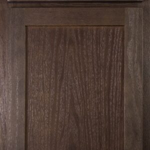 Close-up of a dark wood kitchen cabinet door with a raised panel design.