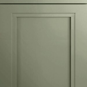 Close-up of a green kitchen cabinet door with decorative molding.