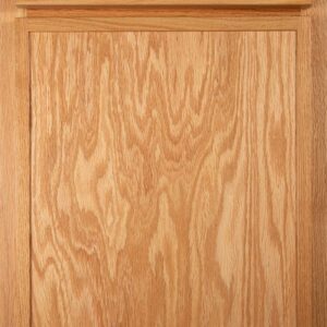 Close-up of a natural wood kitchen cabinet door with a raised panel design.